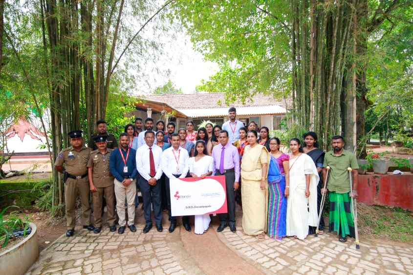 01 Image - D.N.D. Deraniyagala from Gampaha receiving the scholarship at the school with her family members and other representatives. She has been selected to the University of Colombo, (LBN)