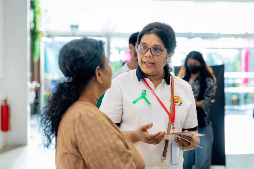 2- Seen here is a Sumithrayo volunteer speaking to a visitor (LBN)